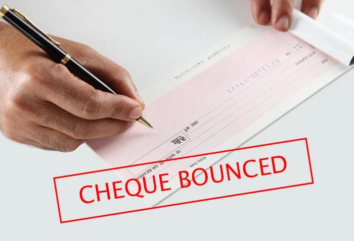 How do I take legal action against a cheque bounce?